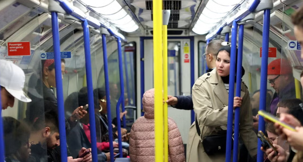 Traveling on the London subway in April. Prime Minister Andy Burnham announced a national campaign against “one of the most annoying things on public transport” — people blasting music or videos from their phone.Credit...Hannah McKay/Reuters