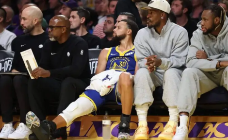 Steph Curry could only sit and watch for the entire fourth quarter of the Warriors loss to the Lakers. Sean M. Haffey / Getty Images