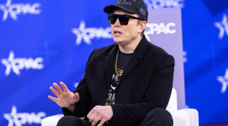 NATIONAL HARBOR, MD, USA — February 20 2025: Elon Musk speaks with Newsmax Host Rob Schmitt on day 1 of the 2025 Conservative Political Action Conference. (Credit: Image via Shutterstock)