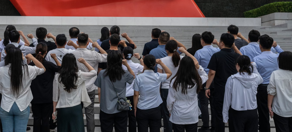 People say an oath of loyalty in front of a flag of the Communist party of China on the 105th anniversary of its founding in Beijing in July. Photograph: Kevin Frayer/Getty Images