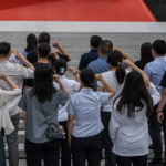 People say an oath of loyalty in front of a flag of the Communist party of China on the 105th anniversary of its founding in Beijing in July. Photograph: Kevin Frayer/Getty Images