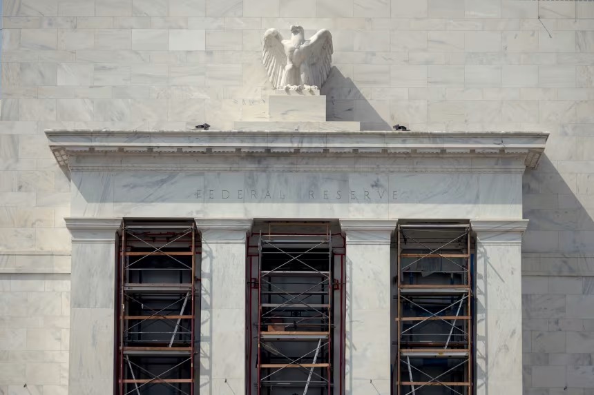 A marble American eagle sculpture sits atop the Marriner S. Eccles Federal Reserve Board Building in Washington, DC, on August 13. Alex Wong/Getty Images