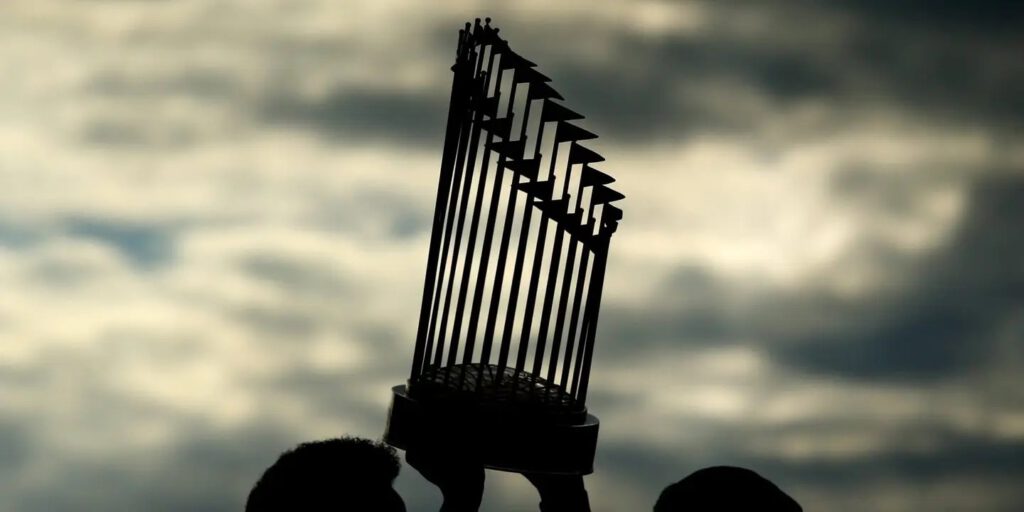 The 2018 Commissioner's Trophy is hoisted at the Red Sox victory parade. Adam Glanzman / Getty Images