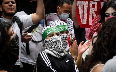 Anti-Zionist protesters wearing Hamas headbands outside Baruch College, in New York City, June 5, 2024. (Luke Tress/Times of Israel)