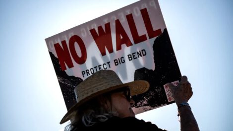 A woman holds a sign to protest the plans to build a section of the border wall at the Big Bend National Park in Study Butte, Texas, on August 15. Photo: Ronaldo Schemidt/ AFP via Getty Images