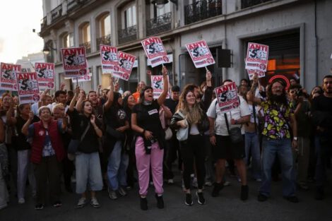 Demonstrators hold placards reading 'Antifascists' during a protest in Madrid against the housing crisis [Alejandro Martinez Velez/Reuters]