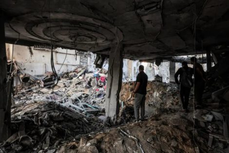 People inspect the damage after an Israeli attack on a residential apartment in the Remal neighbourhood of Gaza City [Omar al-Qattaa/AFP]