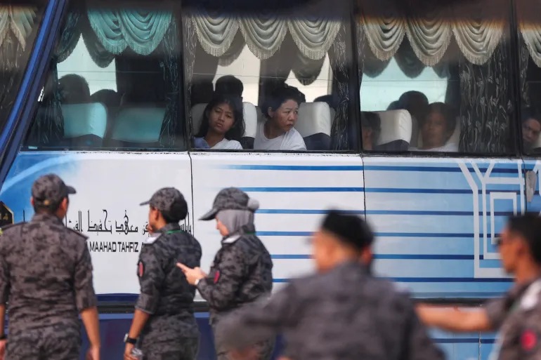 Myanmar nationals to be repatriated from Malaysia sit inside a bus, at Lumut, Malaysia, September 29, 2026 [Hasnoor Hussain/Reuters]