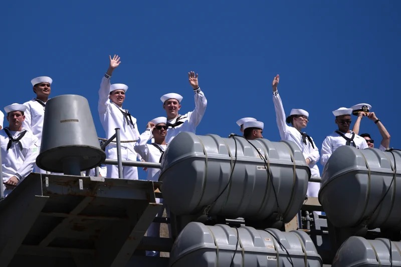 Sailors wave aboard the USS Abraham Lincoln aircraft carrier as it returns to Naval Air Station North Island after deployment Thursday, Oct. 8, 2026, in Coronado, Calif. Gregory Bull/AP