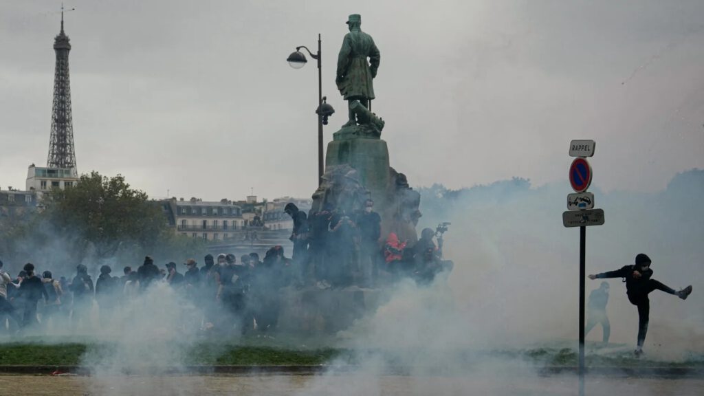 A protester kicks a tear-gas canister during a demonstration of high school students near the Eiffel Tower in Paris on Tuesday. Photo: Dimitar Dilkoff/AFP via Getty Images