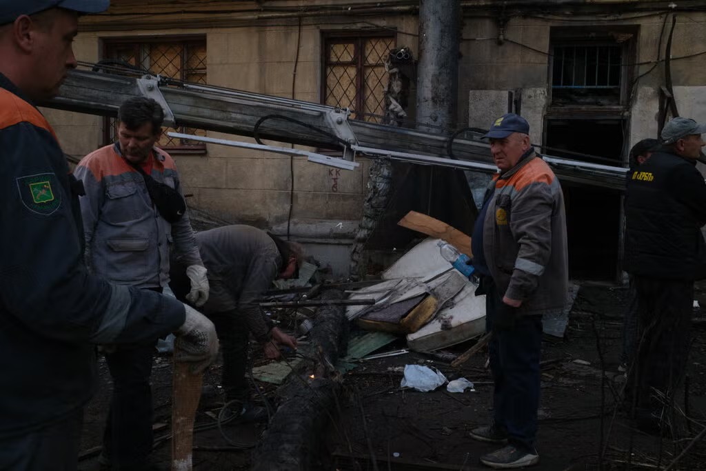 Workers clearing an apartment that was damaged in an attack, in Kharkiv, Ukraine, on Tuesday.Credit...Mauricio Lima for The New York Times
