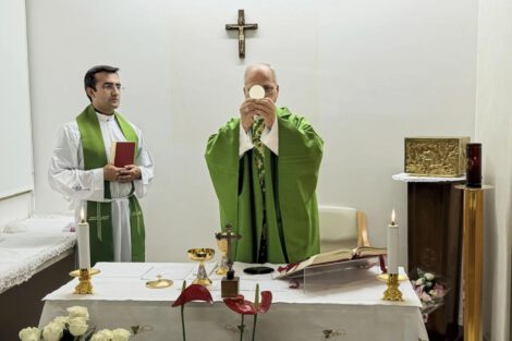 This picture, released by Vatican Media on Friday, Oct. 16, 2026, shows Pope Leo XIV, flanked by his personal secretary, Monsignor Edgard Iván Rimaycuna Inga, left, celebrating Mass at the Agostino Gemelli Polyclinic in Rome, where he is recovering after having cancer removed from his right lung. (Vatican Media via AP)
