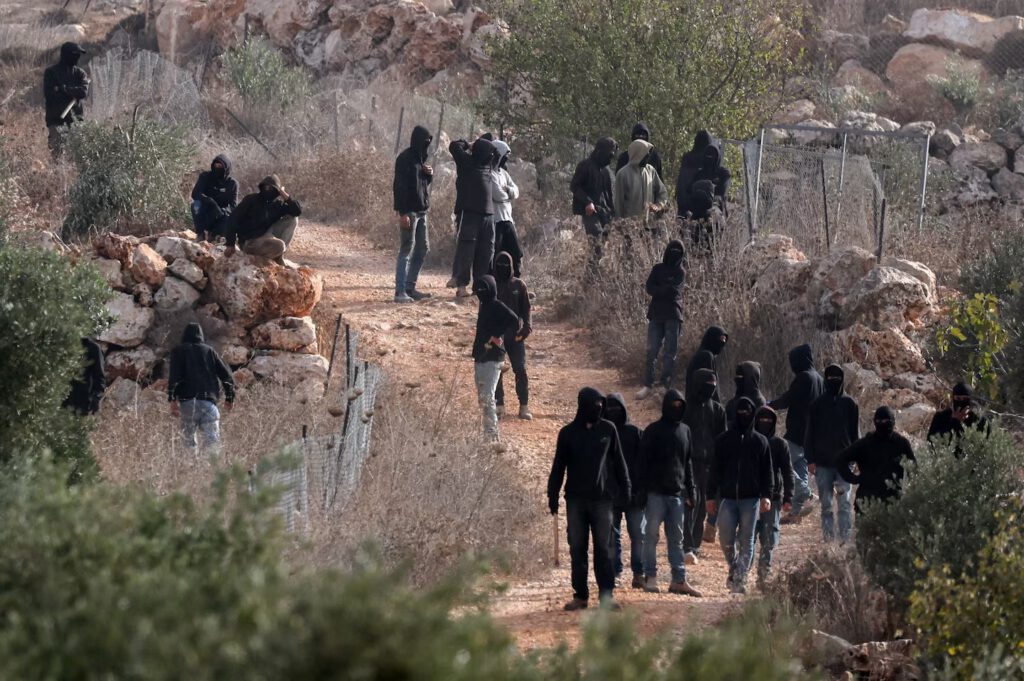 Israeli settlers gather amid clashes with Palestinians during olive harvest in Abu Falah near Ramallah in the Israeli-occupied West Bank on Friday. (Ammar Awad/Reuters)