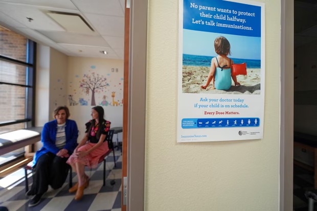 An immunization poster is seen outside an examination room in Lubbock, Texas, on 25 February 2025. Photograph: Julio Cortez/AP